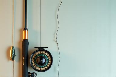 Medium spinning rod and reel setup, ideal for bass fishing from the shore or flatfish in estuaries, with a soft plastic lure.