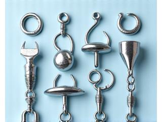 Assortment of hooks, weights, and swivels for fishing.