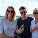 A group of colleagues smiling after a team-building fishing trip.